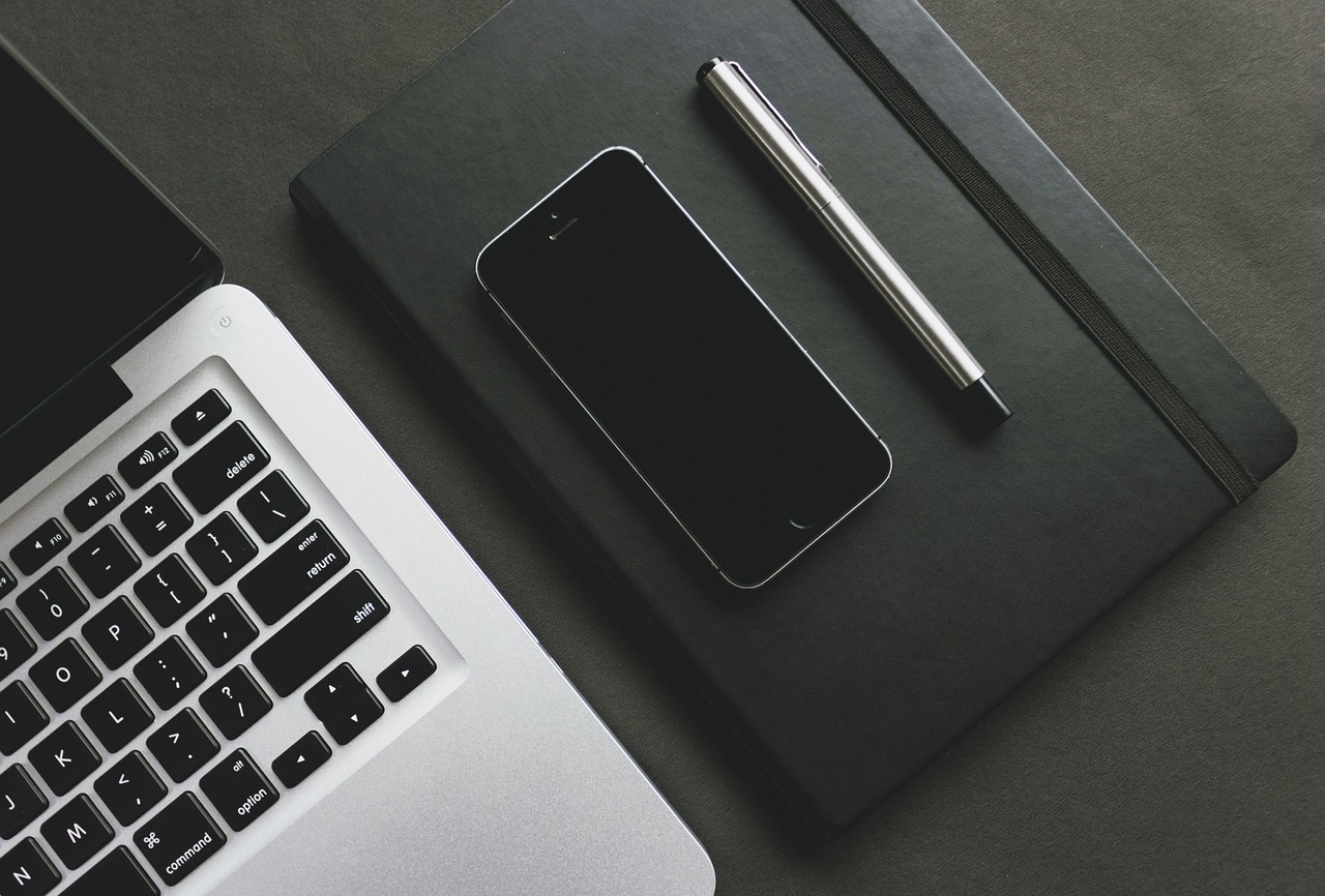 Laptop and keyboard on a minimal clean desk surface